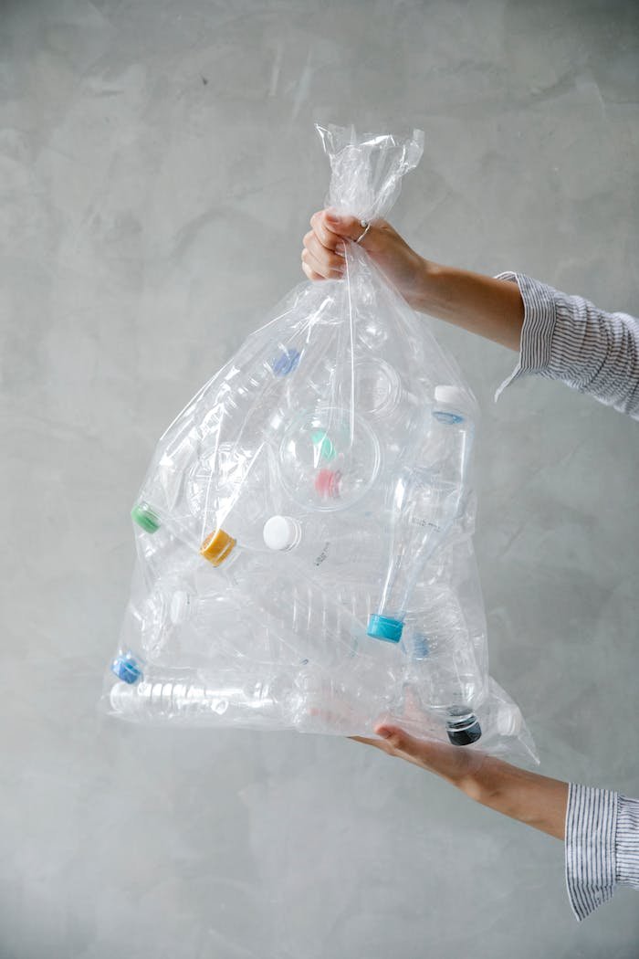A collection of plastic bottles in a clear bag promoting recycling and environmental awareness.